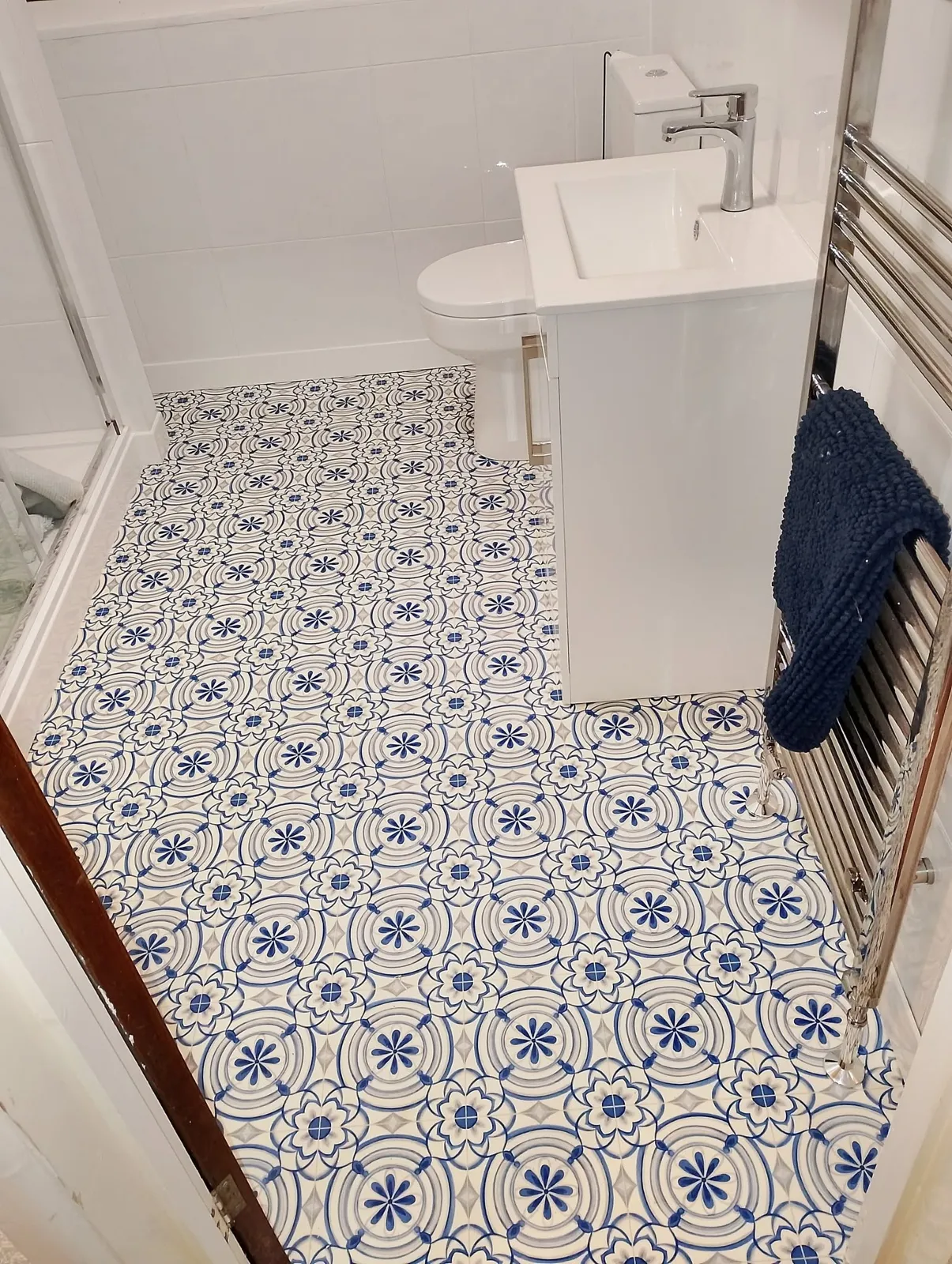New bathroom with vanity unit and patterned floor